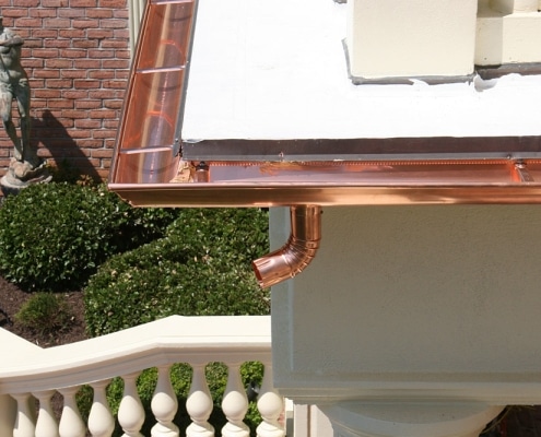 Detailed downspout and gutter transition on brick home