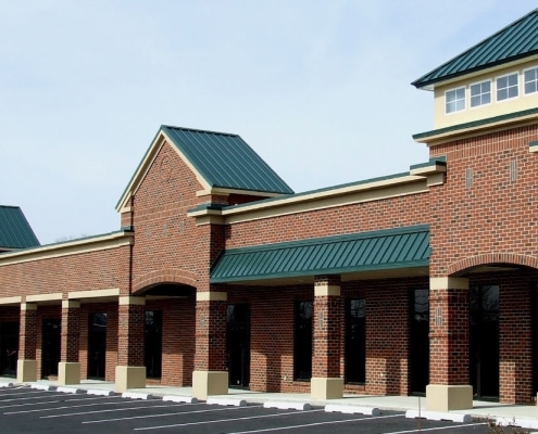 metal-roofing-2 Red metal roofing installed on brick retail complex