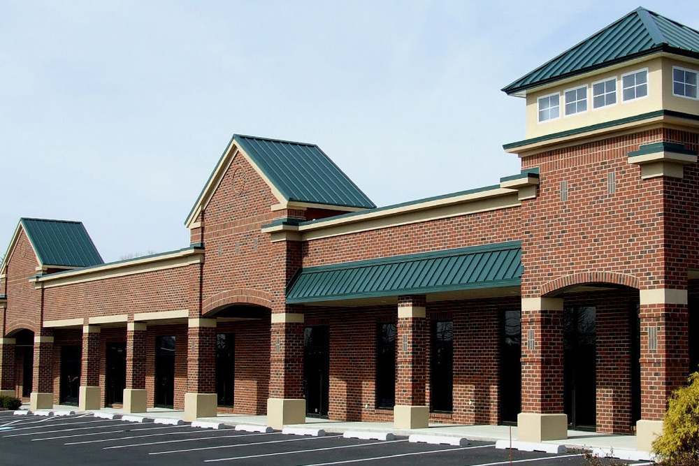 metal-roofing-2 Red metal roofing installed on brick retail complex