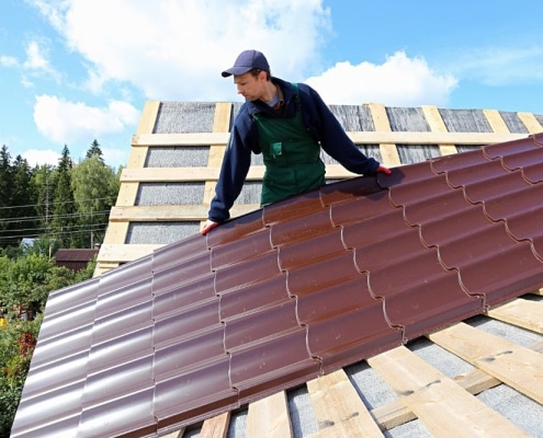 metal-roofing-4 Technician installing white standing seam metal roof