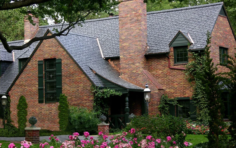 Beautiful brick home with DaVinci synthetic slate roof surrounded by garden