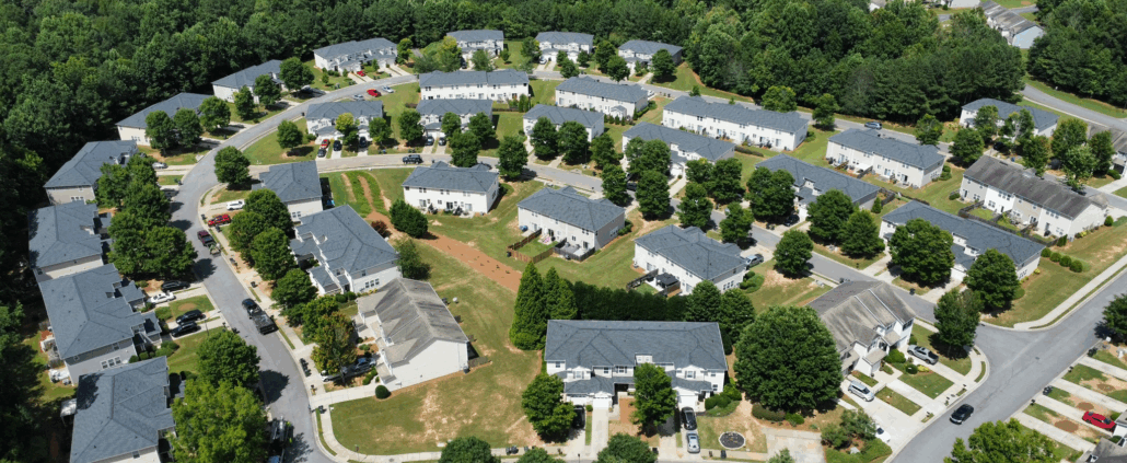 Aerial photo of residential neighborhood in Acworth, GA showing rooftops and surrounding trees