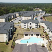 Aerial view of a large apartment complex in Atlanta, GA with well-maintained commercial roofing and a swimming pool