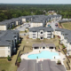 Aerial view of a large apartment complex in Atlanta, GA with well-maintained commercial roofing and a swimming pool