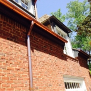 Copper gutter system installed on red brick home in Atlanta – Academy Roofing