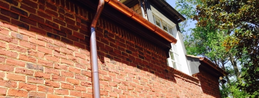Copper gutter system installed on red brick home in Atlanta – Academy Roofing