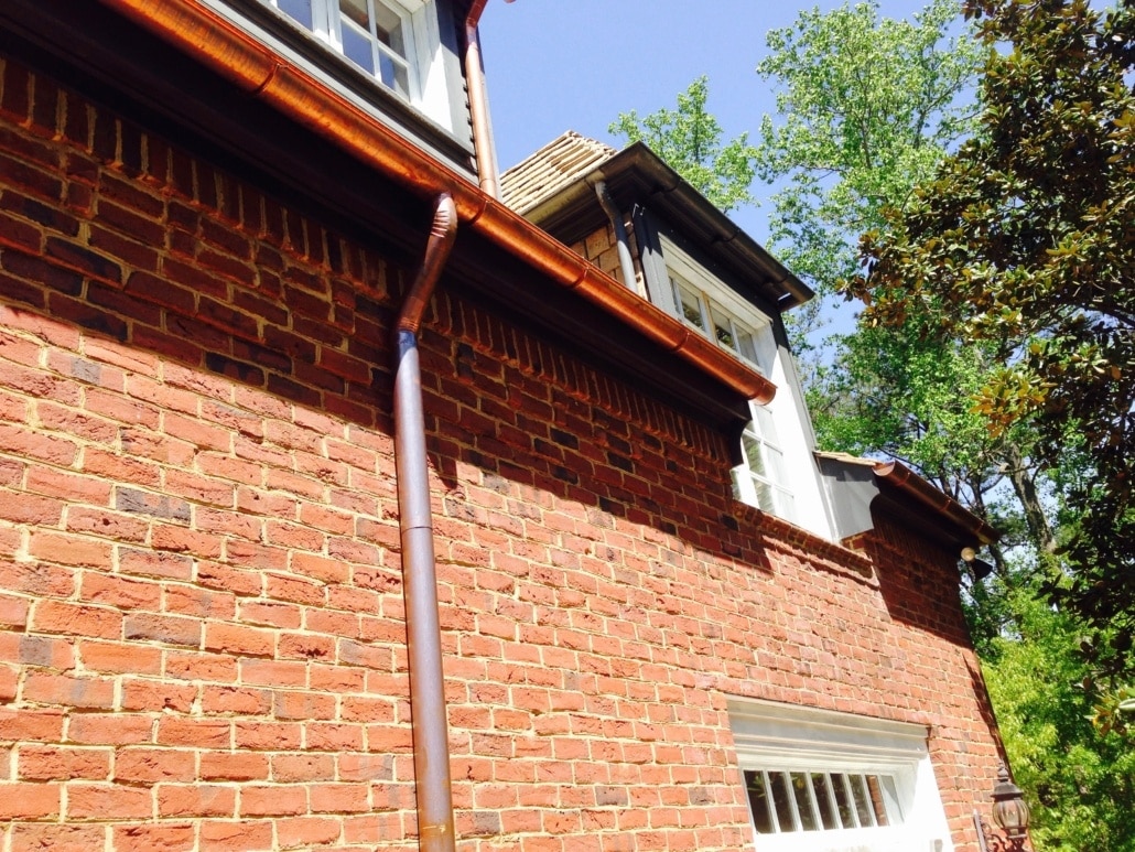 Copper gutter system installed on red brick home in Atlanta – Academy Roofing