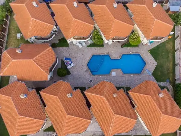 Aerial view of Atlanta townhouses with red clay tile roofing surrounding a central swimming pool